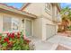 Close-up view of the home's entrance with a garden, featuring a front door and access to the garage at 3709 Misty Falls St, Las Vegas, NV 89129