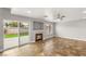 Open-concept living room with tile flooring, a fireplace, and sliding glass doors to the backyard at 3709 Misty Falls St, Las Vegas, NV 89129