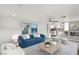 This open living area includes a blue sofa, modern decor and a view into the kitchen at 3709 Misty Falls St, Las Vegas, NV 89129