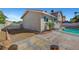 Backyard featuring a swimming pool with new neutral toned stucco exterior and a red tile roof at 3791 El Camino Rd, Las Vegas, NV 89103