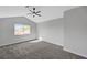 Vaulted bedroom featuring light gray carpeting, a modern ceiling fan, and a window at 3791 El Camino Rd, Las Vegas, NV 89103