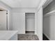 Bedroom closet with white sliding doors and a view of the full bathroom, with neutral walls and carpeting at 3791 El Camino Rd, Las Vegas, NV 89103