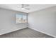 Comfortable bedroom with a large window, ceiling fan, and neutral decor at 3791 El Camino Rd, Las Vegas, NV 89103