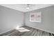 Cozy bedroom featuring updated flooring, a ceiling fan, and a window allowing natural light to fill the space at 3791 El Camino Rd, Las Vegas, NV 89103