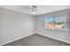 Clean bedroom with large window, ceiling fan, and neutral color scheme at 3791 El Camino Rd, Las Vegas, NV 89103