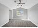 Bedroom featuring vaulted ceilings, a fan, and light gray carpeting at 3791 El Camino Rd, Las Vegas, NV 89103
