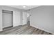 Bedroom showcasing closet, ceiling fan, new floors, neutral paint, and access to other living spaces at 3791 El Camino Rd, Las Vegas, NV 89103