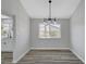 A dining room featuring wood floors and a contemporary light fixture at 3791 El Camino Rd, Las Vegas, NV 89103