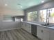 Updated kitchen features new appliances, white cabinets, sleek countertops, and a view to the outdoor living space at 3791 El Camino Rd, Las Vegas, NV 89103