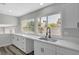 Bright kitchen features white cabinets, sleek countertops, a stylish faucet and modern finishes at 3791 El Camino Rd, Las Vegas, NV 89103