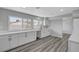 A kitchen featuring white cabinets, stone countertops, and wood floors at 3791 El Camino Rd, Las Vegas, NV 89103