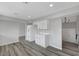 A kitchen featuring white cabinets, stone countertops, and wood floors at 3791 El Camino Rd, Las Vegas, NV 89103