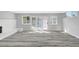 Spacious living area featuring updated flooring, a fireplace, and double doors leading to a pool area at 3791 El Camino Rd, Las Vegas, NV 89103