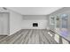 Bright living room with a white brick fireplace, modern flooring, and access to the outdoors through glass doors at 3791 El Camino Rd, Las Vegas, NV 89103