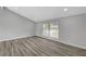 Bright living room with large window and laminate floors at 3791 El Camino Rd, Las Vegas, NV 89103