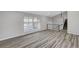 Bright living room with large windows and laminate floors at 3791 El Camino Rd, Las Vegas, NV 89103