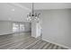 A bright living room featuring wood floors and a contemporary light fixture at 3791 El Camino Rd, Las Vegas, NV 89103