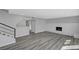 View of open concept living room featuring staircase, fireplace and light gray plank flooring throughout at 3791 El Camino Rd, Las Vegas, NV 89103
