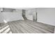 Open-concept living room with staircase featuring light gray plank flooring and a bright open design at 3791 El Camino Rd, Las Vegas, NV 89103