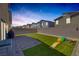 Inviting backyard featuring a lush lawn, brick patio, and playful slide at 3808 Seyfert Ave, North Las Vegas, NV 89084