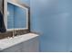 Bathroom features a double sink vanity with modern fixtures and a wood-framed mirror at 3808 Seyfert Ave, North Las Vegas, NV 89084