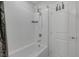 Clean, white bathroom featuring a tub and shower combination with sleek, modern fixtures at 3808 Seyfert Ave, North Las Vegas, NV 89084