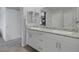 Bright bathroom featuring double sinks, granite countertops, and modern white cabinets at 3808 Seyfert Ave, North Las Vegas, NV 89084