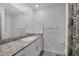 Bright bathroom featuring a granite countertop, white vanity, and decorative shower curtain at 3808 Seyfert Ave, North Las Vegas, NV 89084