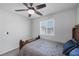 Bright bedroom featuring a ceiling fan, a wooden bed frame, and a window at 3808 Seyfert Ave, North Las Vegas, NV 89084