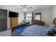 Comfortable bedroom with a wooden dresser, large window, and neutral decor at 3808 Seyfert Ave, North Las Vegas, NV 89084
