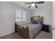 Bright bedroom featuring a ceiling fan, a wooden bed frame, and a window at 3808 Seyfert Ave, North Las Vegas, NV 89084