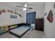 bedroom featuring a ceiling fan, a platform bed with bookshelves, and decor with a train theme at 3808 Seyfert Ave, North Las Vegas, NV 89084