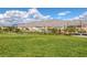 Large green community park view, with low growing trees and shrubs, homes and mountains in the background at 3808 Seyfert Ave, North Las Vegas, NV 89084