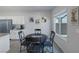Bright dining area with a window, neutral walls, tile floor and open to the kitchen at 3808 Seyfert Ave, North Las Vegas, NV 89084
