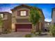Inviting two-story home featuring a red garage door, landscaped yard, and a welcoming entrance at 3808 Seyfert Ave, North Las Vegas, NV 89084