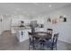 Well-lit kitchen with granite counters, stainless appliances, a central island and dining area at 3808 Seyfert Ave, North Las Vegas, NV 89084