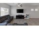 Comfortable living room with sectional sofa and large TV, illuminated by natural light at 3808 Seyfert Ave, North Las Vegas, NV 89084