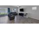 Comfortable living room with a sectional sofa and entertainment center, filled with natural light at 3808 Seyfert Ave, North Las Vegas, NV 89084