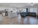 Open floor plan shows kitchen, dining area, and spacious living room with a sectional sofa at 3808 Seyfert Ave, North Las Vegas, NV 89084