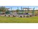 Community playground featuring sunshades, play equipment, and landscaped with trees, shrubs, and greenery at 3808 Seyfert Ave, North Las Vegas, NV 89084