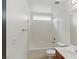 Bathroom with white subway tile surround the tub and shower, with a cherry vanity at 4517 Lime Straight Dr, Las Vegas, NV 89115
