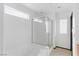 White bathroom with a glass shower enclosure over a soaking tub at 4517 Lime Straight Dr, Las Vegas, NV 89115