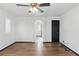 Clean bedroom with a ceiling fan, a large window, and wood flooring at 4517 Lime Straight Dr, Las Vegas, NV 89115