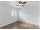 Bright bedroom features ceiling fan, and window with wood-look flooring at 4517 Lime Straight Dr, Las Vegas, NV 89115