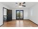 Bright bedroom with ceiling fan and access to balcony through double glass doors at 4517 Lime Straight Dr, Las Vegas, NV 89115