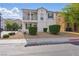 Two-story home featuring a balcony, neutral-toned exterior, manicured landscaping, and a welcoming entrance at 4517 Lime Straight Dr, Las Vegas, NV 89115