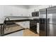Modern kitchen features black countertops, stainless steel appliances, and white cabinets at 4517 Lime Straight Dr, Las Vegas, NV 89115