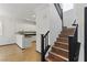 Open kitchen area with breakfast bar and wooden staircase at 4517 Lime Straight Dr, Las Vegas, NV 89115