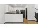 Modern kitchen boasts white cabinets, stainless steel appliances, granite countertops, and a breakfast bar at 4517 Lime Straight Dr, Las Vegas, NV 89115