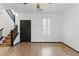 Inviting living room features wood-look tile flooring, plantation shutters, and a staircase at 4517 Lime Straight Dr, Las Vegas, NV 89115
